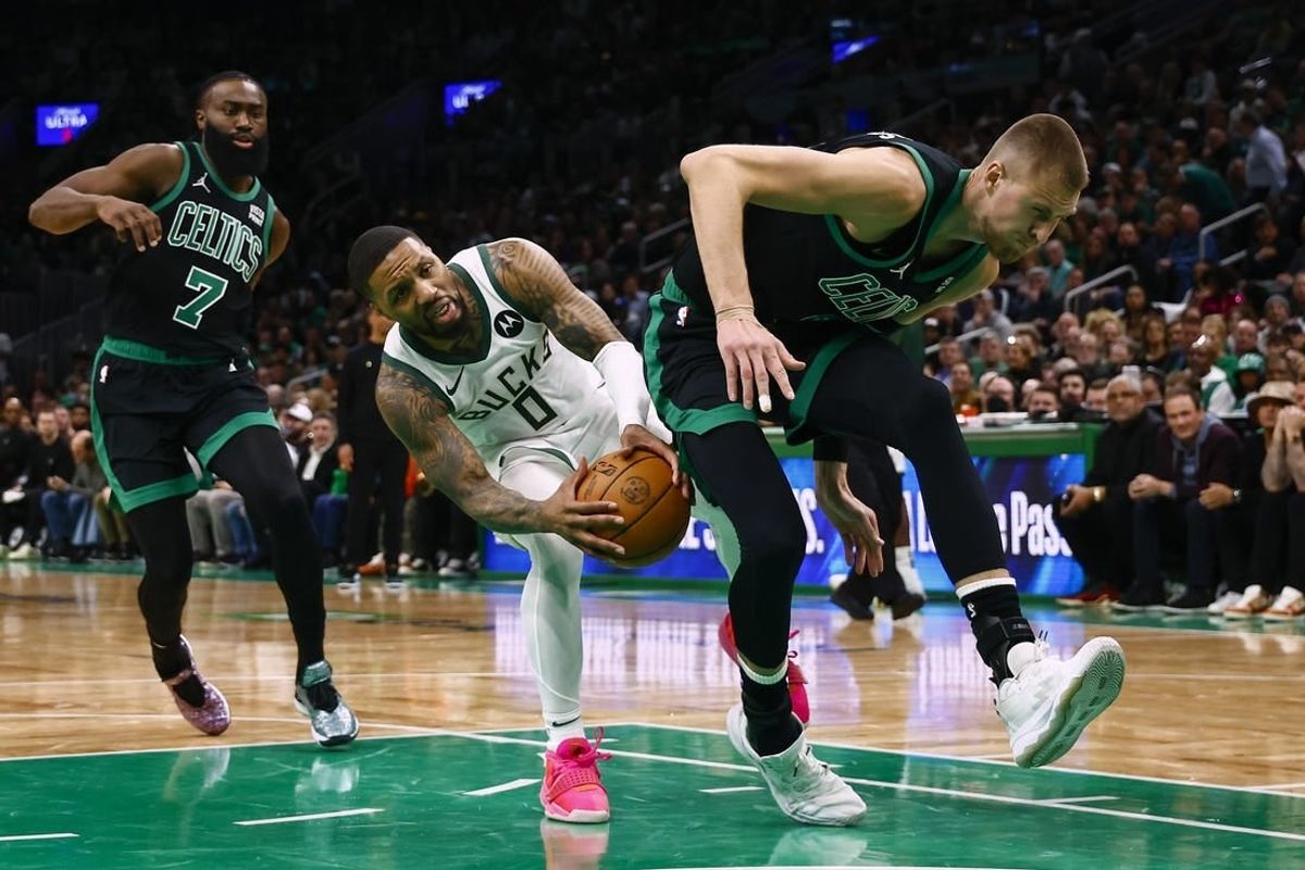 Mar 20, 2024; Boston, Massachusetts, USA; Milwaukee Bucks guard Damian Lillard (0) runs into the back of Boston Celtics center Kristaps Porzingis (8) during the second quarter at TD Garden.