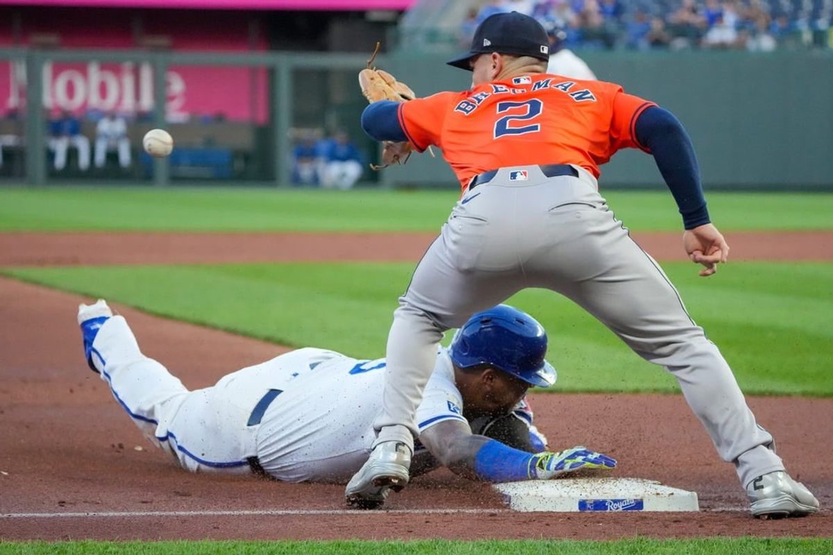 Apr 9, 2024; Kansas City, Missouri, USA; Houston Astros third base Alex Bregman (2) can’t make the tag as Kansas City Royals catcher Salvador Perez (13) slides into third base safely in the third inning at Kauffman Stadium.