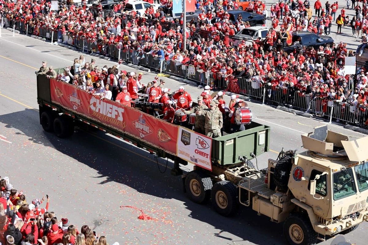 Feb 14, 2024; Kansas City, MO, USA; Fan watch the parade procession during the celebration of the Kansas City Chiefs winning Super Bowl LVIII.