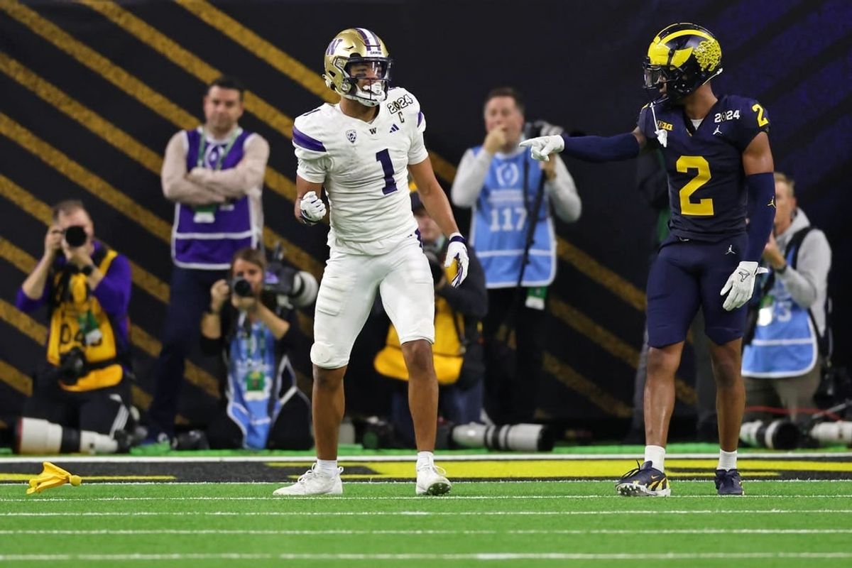 Jan 8, 2024; Houston, TX, USA; Washington Huskies wide receiver Rome Odunze (1) and Michigan Wolverines defensive back Will Johnson (2) react after a flag was thrown during the fourth quarter in the 2024 College Football Playoff national championship game at NRG Stadium.