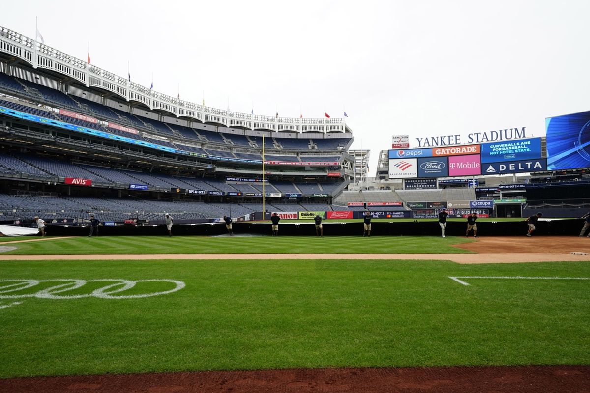 Sep 11, 2022; Bronx, New York, USA;  The grounds crew pull the tarp onto the field prior to the game at Yankee Stadium. Mandatory Credit: Gregory Fisher-USA TODAY Sports
