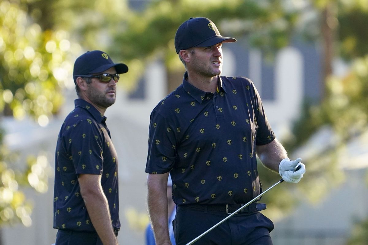 Sep 23, 2022; Charlotte, North Carolina, USA; International Team golfer Corey Conners (left) and golfer Taylor Pendrith (right) on the 18th hole during the four-ball match play of the Presidents Cup golf tournament at Quail Hollow Club. Mandatory Credit: Peter Casey-USA TODAY Sports