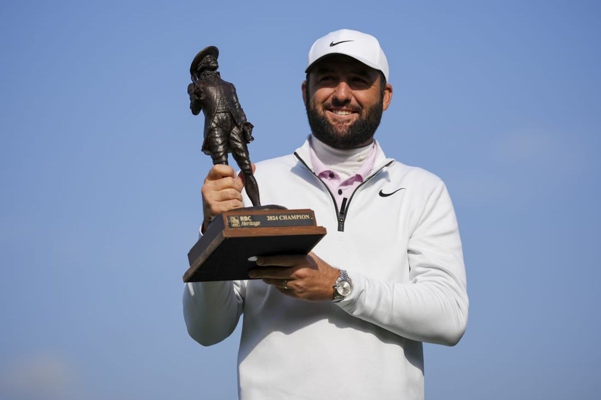 Apr 22, 2024; Hilton Head, South Carolina, USA; Scottie Scheffler poses for a photo with the trophy after winning the RBC Heritage golf tournament. Play was suspended on Sunday, due to inclement weather.