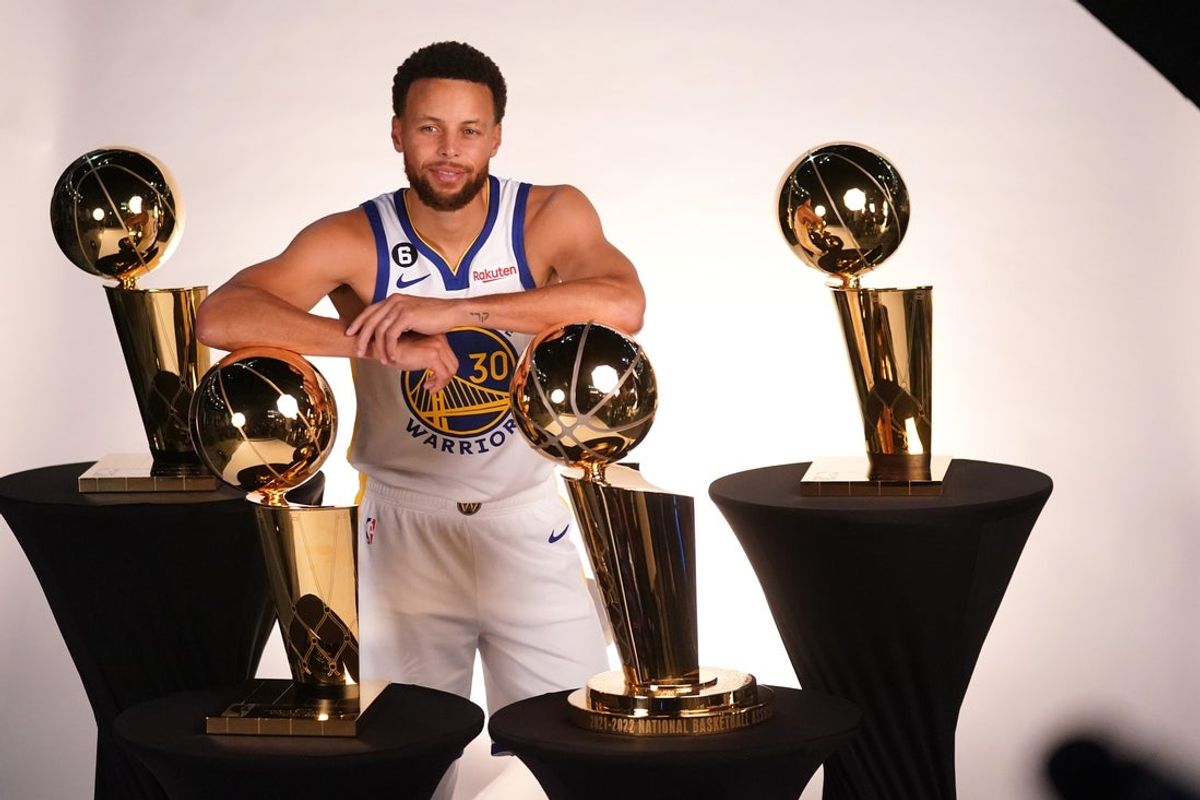 Sep 25, 2022; San Francisco, CA, USA; Golden State Warriors guard Stephen Curry (30) poses with the Larry O'Brien Championship Trophies during Media Day at the Chase Center. Mandatory Credit: Cary Edmondson-Imagn Images