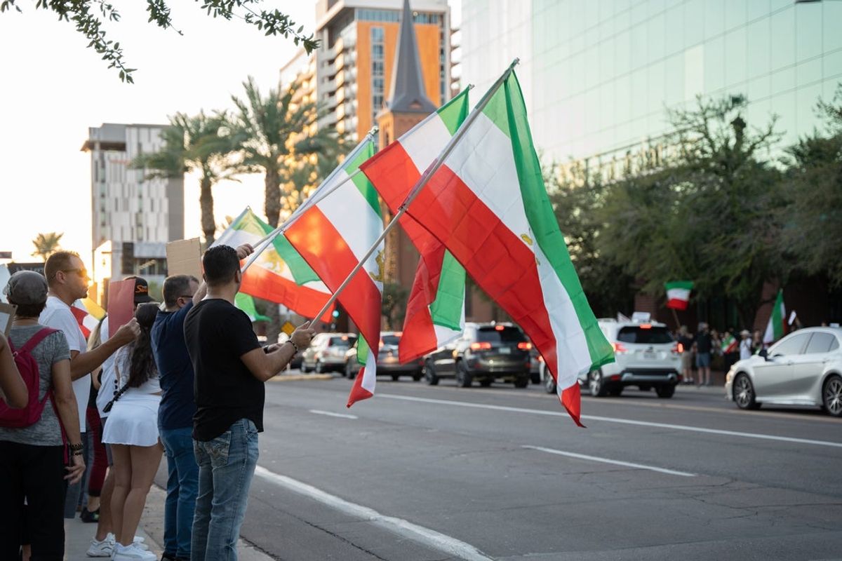Demonstrators wave Iranian flags in solidarity with the people of Iran during a rally at Arizona State University in Tempe on Oct. 1, 2022.

News Support Women In Iran Solidarity Event
