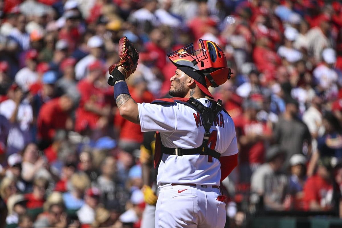 Oct 2, 2022; St. Louis, Missouri, USA; St. Louis Cardinals catcher Yadier Molina (4) waves toward the crowd before his final regular season home game during the first inning against the Pittsburgh Pirates  at Busch Stadium. Mandatory Credit: Jeff Curry-Imagn Images