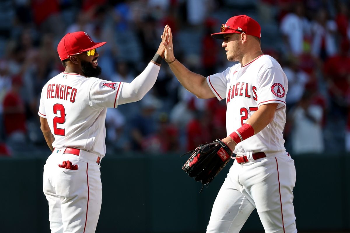 Oct 2, 2022; Anaheim, California, USA; Los Angeles Angels third baseman Luis Rengifo (2) and center fielder Mike Trout (27) celebrate a victory against the Texas Rangers at Angel Stadium. Mandatory Credit: Kiyoshi Mio-USA TODAY Sports