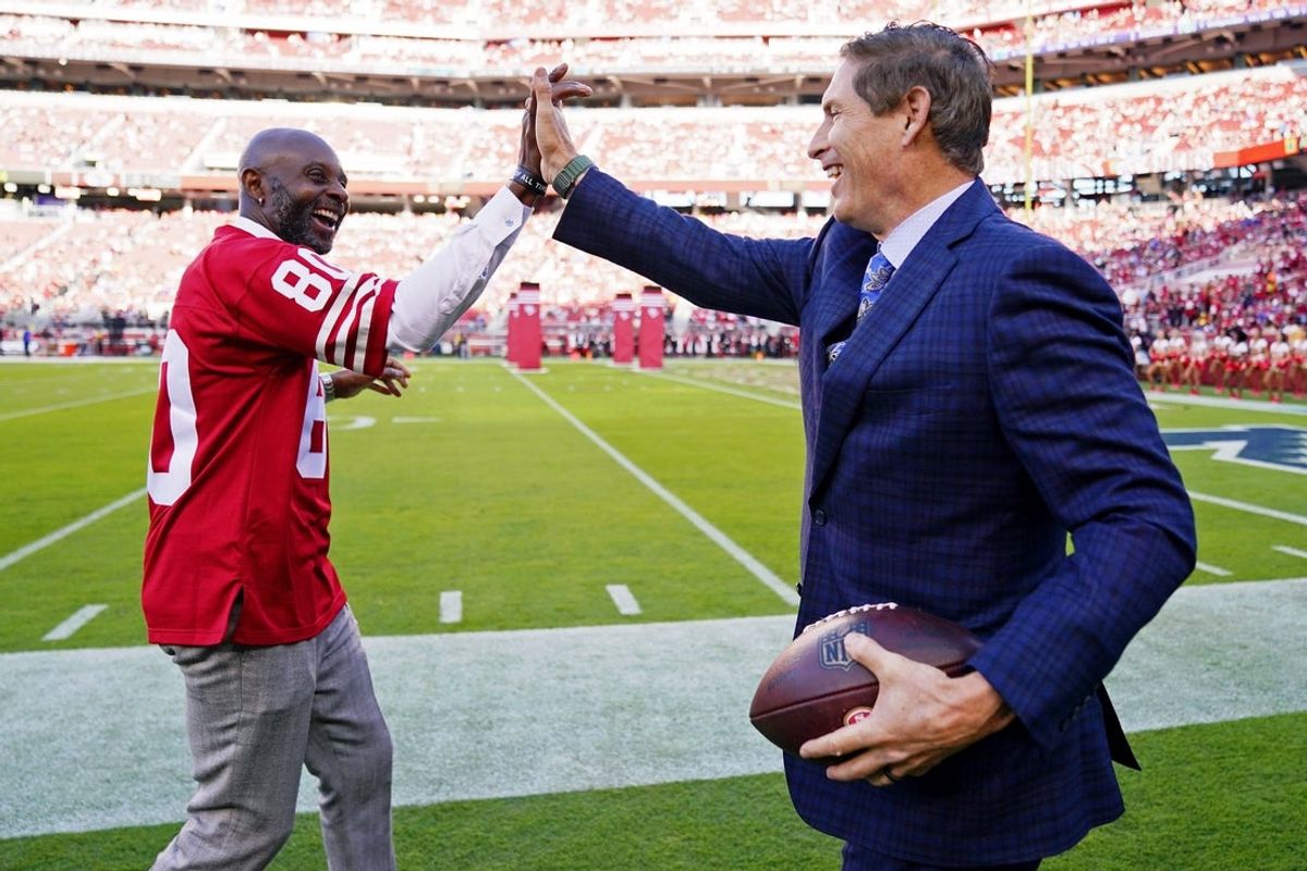 Oct 3, 2022; Santa Clara, California, USA; San Francisco 49ers former player Jerry Rice (left) and former player Steve Young high five before the game between the San Francisco 49ers and the Los Angeles Rams at Levi's Stadium. Mandatory Credit: Kyle Terada-Imagn Images