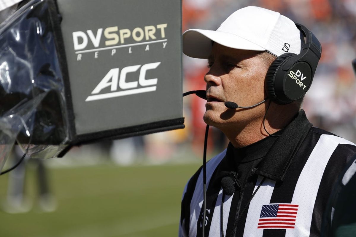 Oct 8, 2022; Charlottesville, Virginia, USA; Referee Gary Patterson reviews a call on the field during the game between the Louisville Cardinals and the Virginia Cavaliers during the third quarter at Scott Stadium. Mandatory Credit: Geoff Burke-Imagn Images