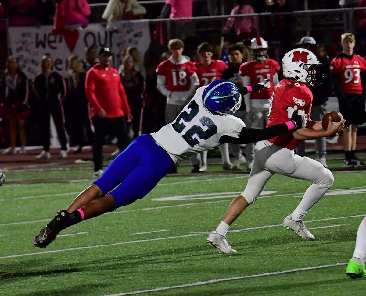Milford quarterback Austin Hardin runs out of the would-be tackle of Winton Woods' Justin Hill (22) at the Winton Woods vs. Milford Eastern Cincinnati Conference football game, Oct. 7, 2022.

Mw 114