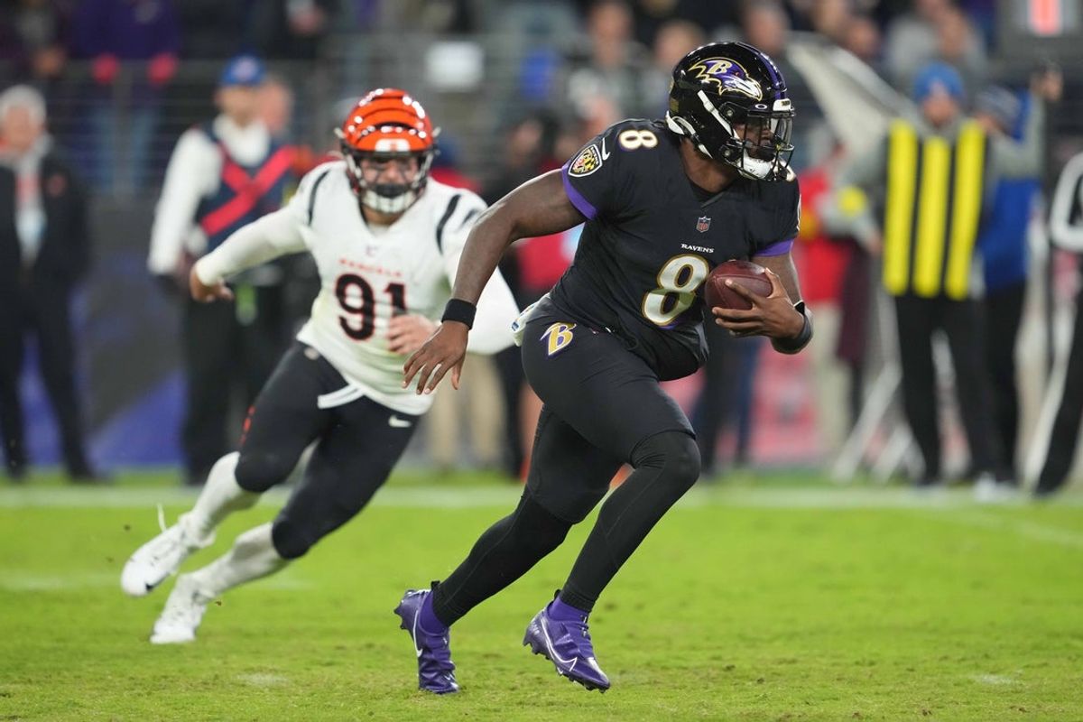 Oct 9, 2022; Baltimore, Maryland, USA; Baltimore Ravens quarterback Lamar Jackson (8) runs for a third quarter gain defended by Cincinnati Bengals defensive end Trey Hendrickson (91) at M&T Bank Stadium. Mandatory Credit: Mitch Stringer-Imagn Images