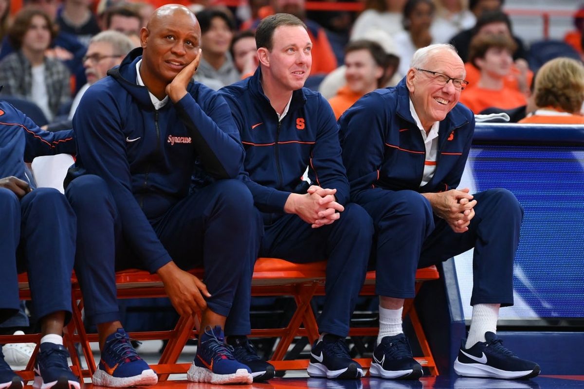Oct 14, 2022; Syracuse, New York, US; Syracuse Orange associate head coach Adrian Autry (left) and assistant coach Gerry McNamara (center) and head coach Jim Boeheim (right) watch the action at the Orange Tip Off at the JMA Wireless Dome. Mandatory Credit: Rich Barnes-Imagn Images
