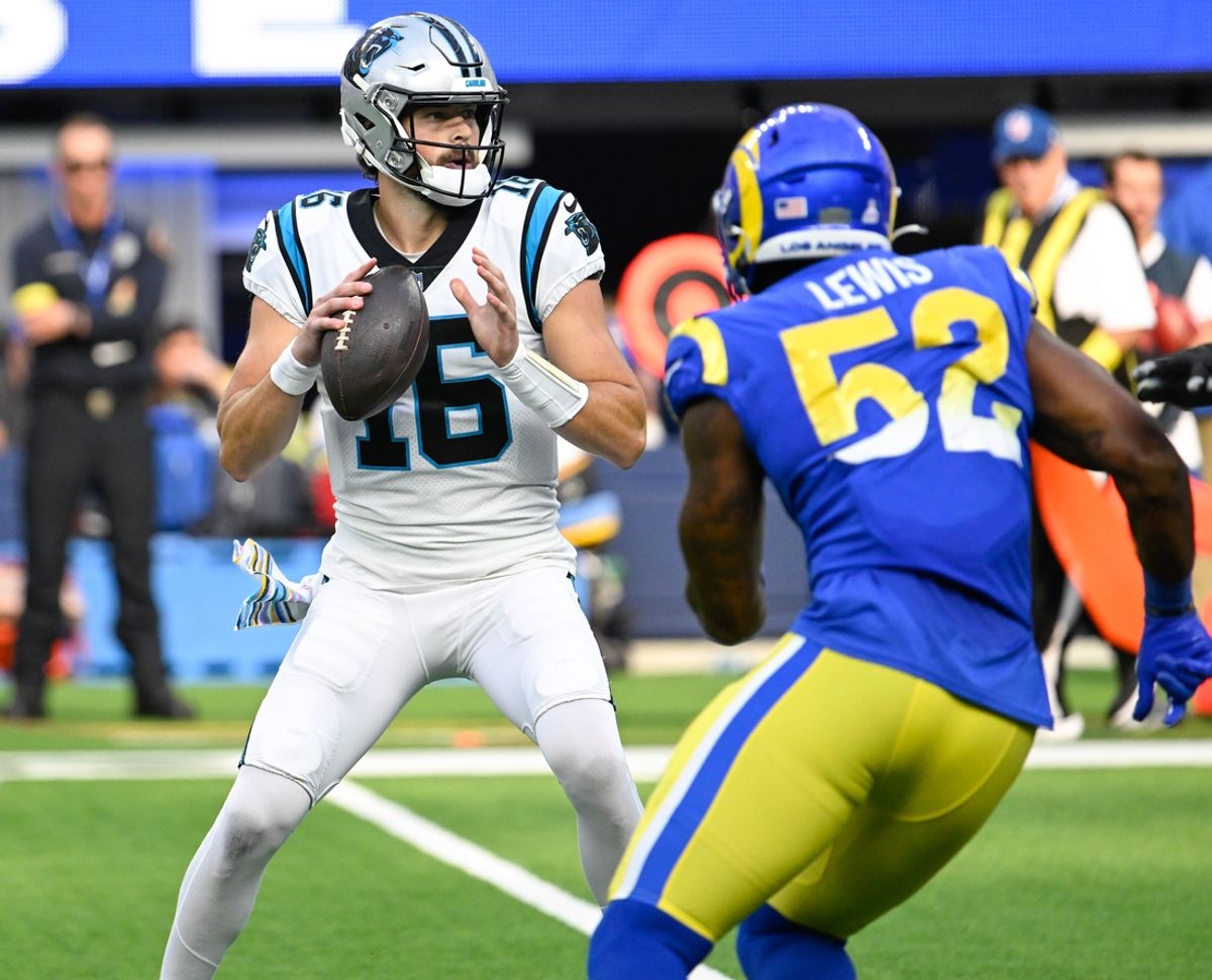 Oct 16, 2022; Inglewood, California, USA; Carolina Panthers quarterback Jacob Eason (16) and Los Angeles Rams linebacker Terrell Lewis (52) during the second half at SoFi Stadium. Mandatory Credit: Robert Hanashiro-USA TODAY Sports