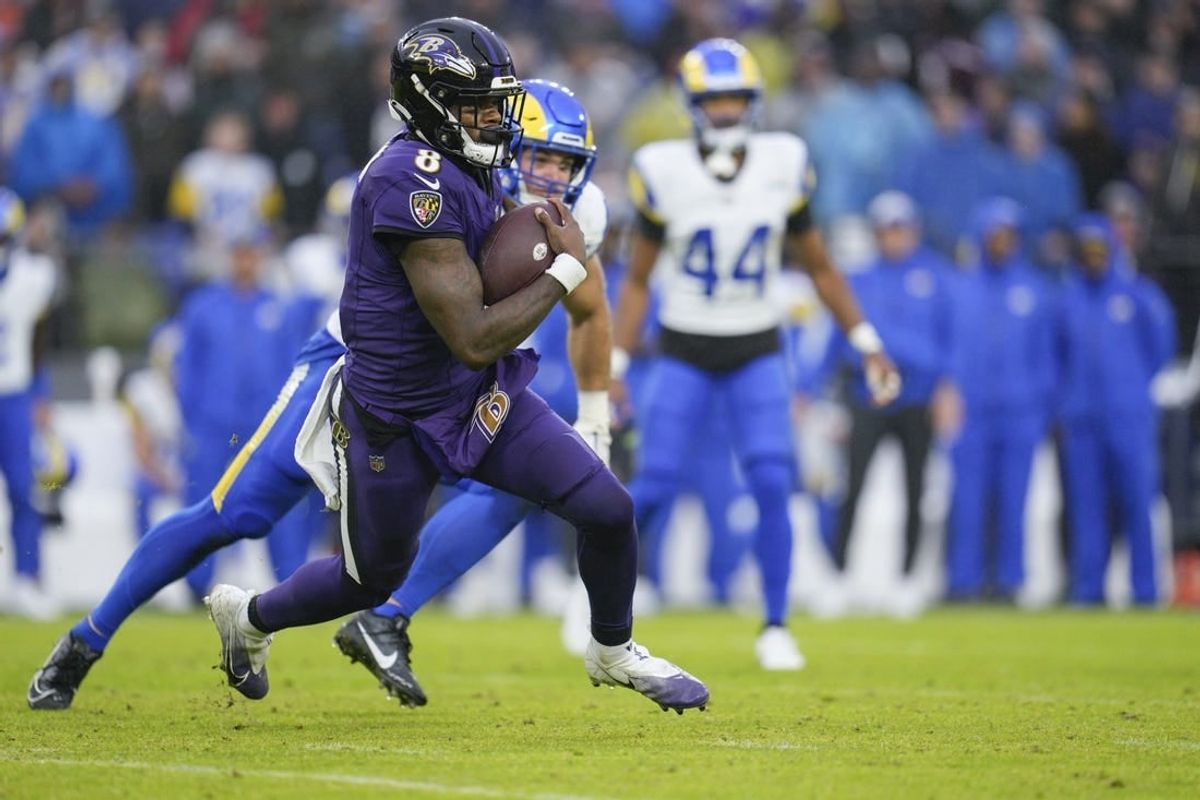 Dec 10, 2023; Baltimore, Maryland, USA;  Baltimore Ravens quarterback Lamar Jackson (8) runs with the ball against the Los Angeles Rams during the second half at M&T Bank Stadium.