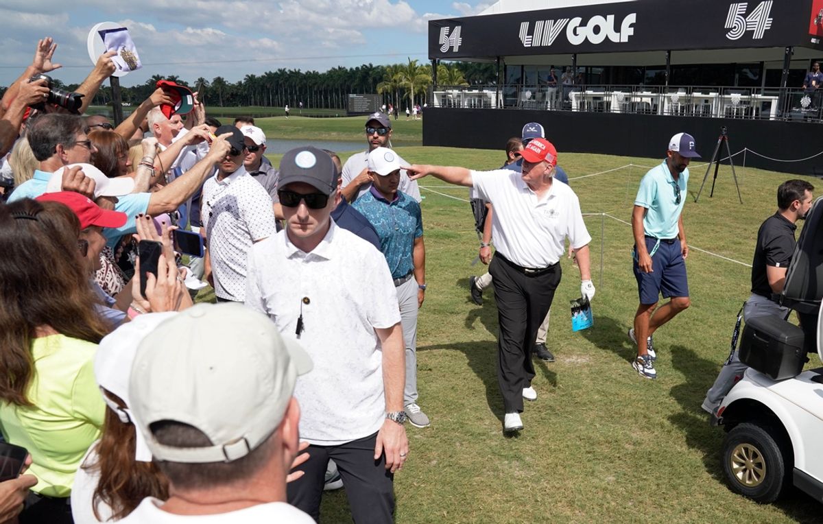 Oct 27, 2022; Miami, Florida, USA; Former President Donald Trump waves to supporters following his round in the Pro-Am tournament before the LIV Golf series at Trump National Doral. Mandatory Credit: John David Mercer-Imagn Images