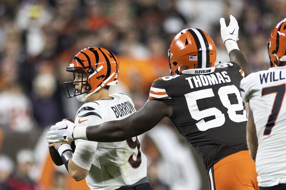 Oct 31, 2022; Cleveland, Ohio, USA; Cleveland Browns defensive end Isaiah Thomas (58) sacks Cincinnati Bengals quarterback Joe Burrow (9) during the second quarter at FirstEnergy Stadium. Mandatory Credit: Scott Galvin-Imagn Images