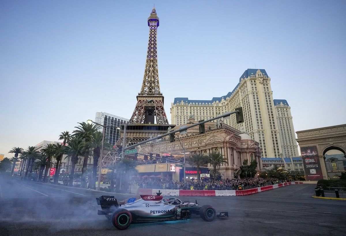 Nov 5, 2022; Las Vegas, Nevada, USA;  Mercedes-AMG Petronas driver George Russell spins his car on the track during the Formula One Las Vegas Grand Prix Launch Party at Las Vegas Strip. Mandatory Credit: Ray Acevedo-Imagn Images
