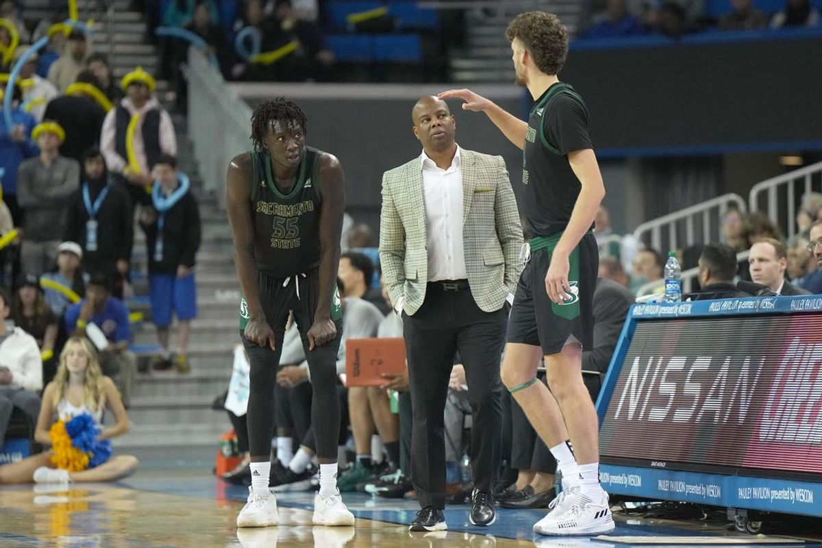 Nov 7, 2022; Los Angeles, California, USA; Sacramento State Hornets head coach David Patrick (center) talks with forward Akol Mawein (55) and forward Hunter Marks (0) in the second half against the UCLA Bruins at Pauley Pavilion. Mandatory Credit: Kirby Lee-USA TODAY Sports