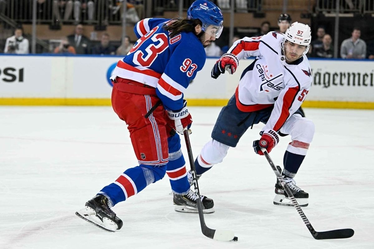 Apr 23, 2024; New York, New York, USA;  New York Rangers center Mika Zibanejad (93) attempts a shot defended by Washington Capitals defenseman Trevor van Riemsdyk (57) during the first period in game two of the first round of the 2024 Stanley Cup Playoffs at Madison Square Garden.