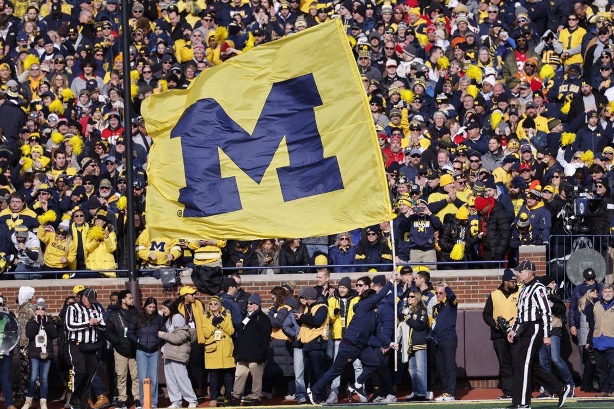 Nov 25, 2023; Ann Arbor, Michigan, USA; Michigan Wolverines cheerleader celebrates a touchdown against the Ohio State Buckeyes in the first half at Michigan Stadium.