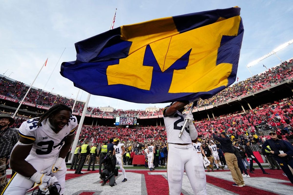 Nov 26, 2022; Columbus, Ohio, USA;  Michigan Wolverines linebacker Michael Barrett (23) waves the Michigan flag following their 45-23 win over the Ohio State Buckeyes in the NCAA football game at Ohio Stadium. Mandatory Credit: Adam Cairns-The Columbus Dispatch

Ncaa Football Michigan Wolverines At Ohio State Buckeyes