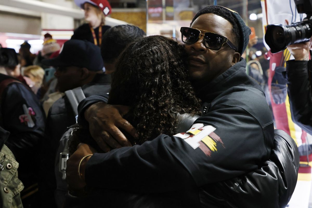Nov 27, 2022; Landover, Maryland, USA; Jackie Taylor, daughter of former Washington Redskins safety Sean Taylor (L) hugs former Redskinsplayer Clinton Portis (R) at the unveiling of a memorial honoring the 15th year of Taylor's passing prior to the Commanders' game against the Atlanta Falcons at FedExField. Mandatory Credit: Geoff Burke-Imagn Images