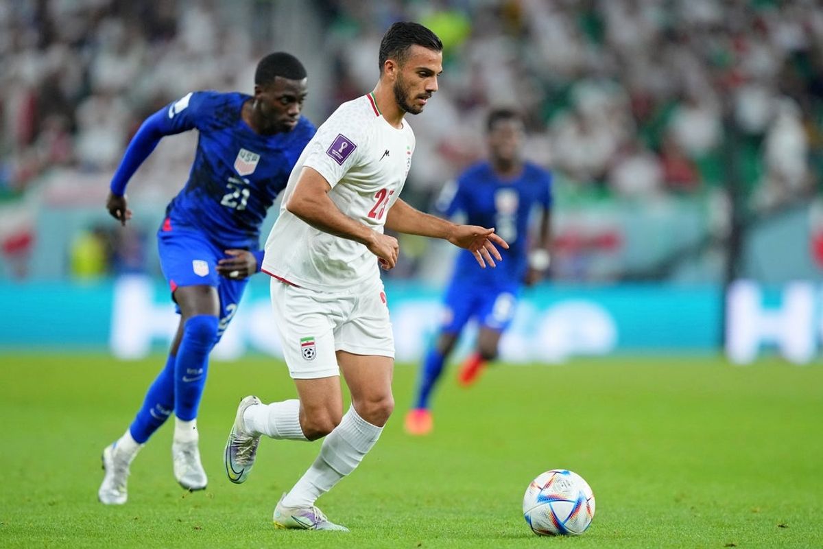 Nov 29, 2022; Doha, Qatar; Iran defender Abolfazl Jalali (25) dribbles the ball against the United States of America during the second half of a group stage match during the 2022 World Cup at Al Thumama Stadium. Mandatory Credit: Danielle Parhizkaran-Imagn Images