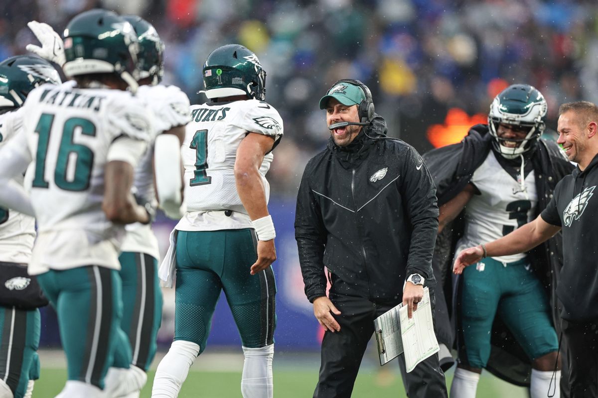 Dec 11, 2022; East Rutherford, New Jersey, USA; Philadelphia Eagles assistant coach Kevin Patullo celebrates with quarterback Jalen Hurts (1) after a touchdown during the second half against the New York Giants at MetLife Stadium. Mandatory Credit: Vincent Carchietta-Imagn Images