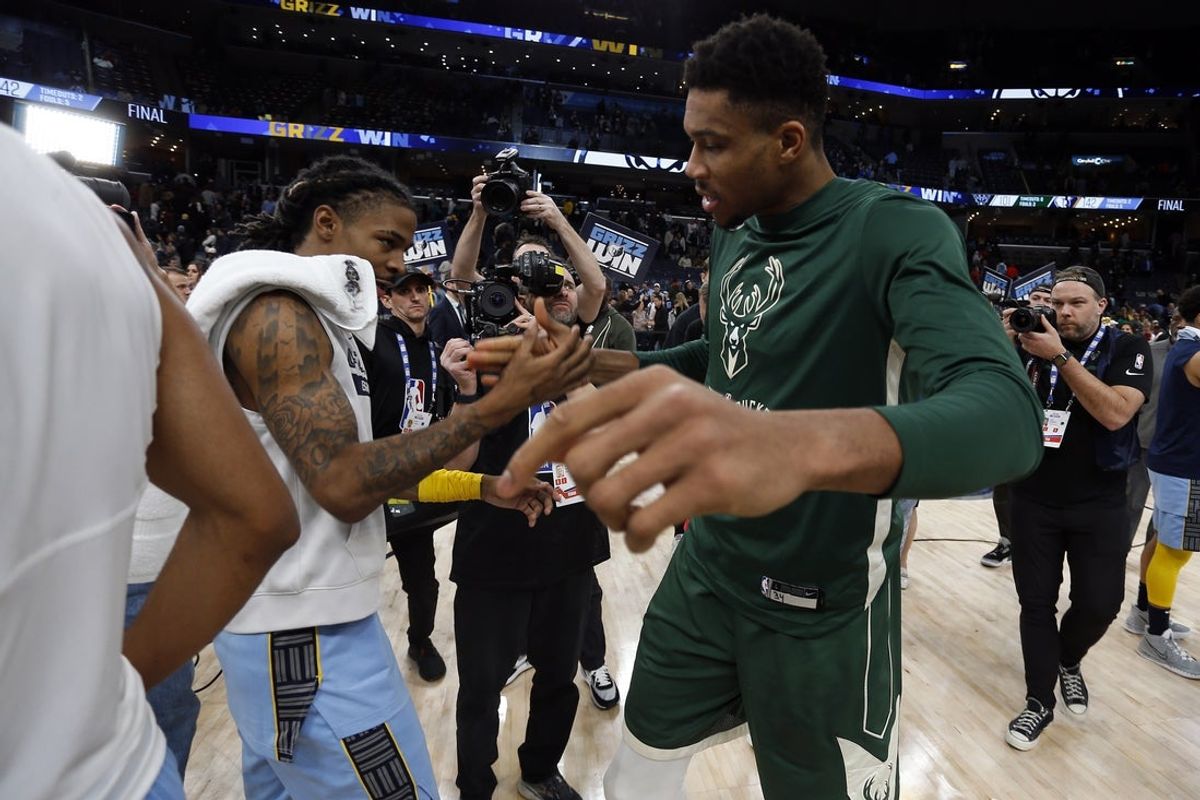 Dec 15, 2022; Memphis, Tennessee, USA; Memphis Grizzlies guard Ja Morant (left) and Milwaukee Bucks forward Giannis Antetokounmpo (34) shake hands after the game at FedExForum. Mandatory Credit: Petre Thomas-Imagn Images