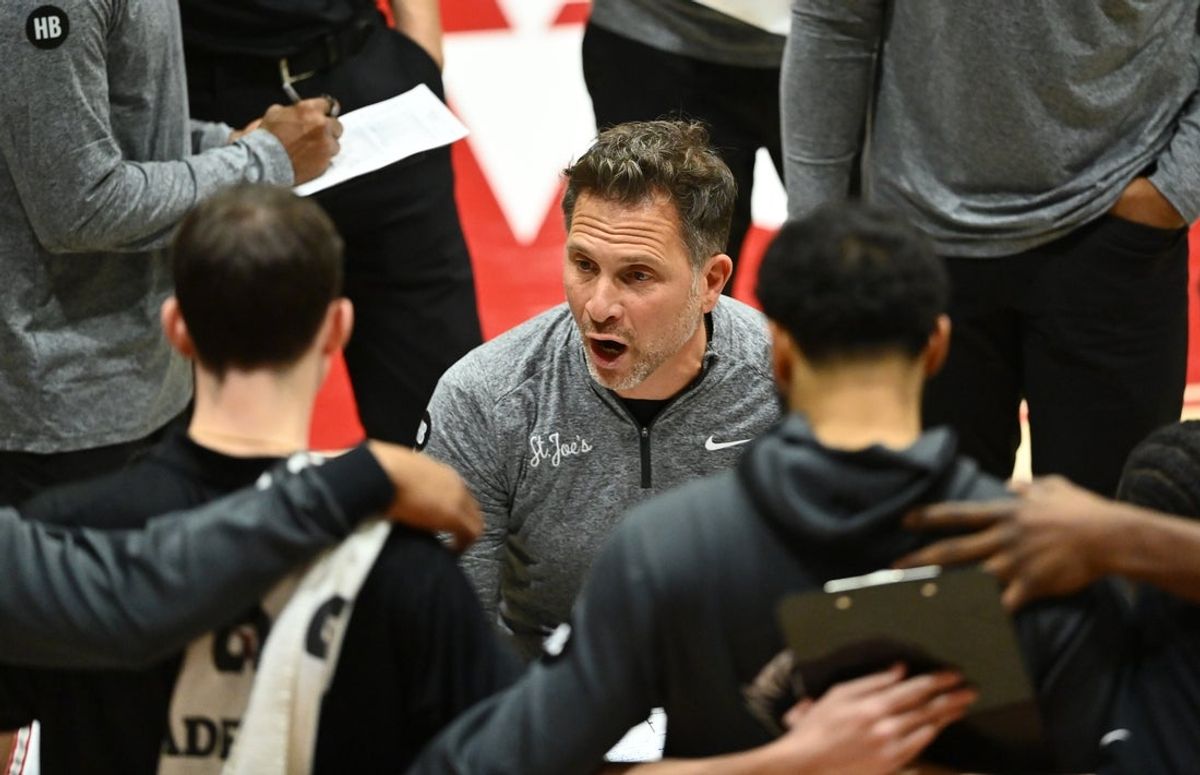 Dec 17, 2022; Philadelphia, Pennsylvania, USA; Saint Joseph's Hawks head coach Billy Lange leads a huddle against the Villanova Wildcats in the second half at Michael J. Hagan Arena. Mandatory Credit: Kyle Ross-Imagn Images