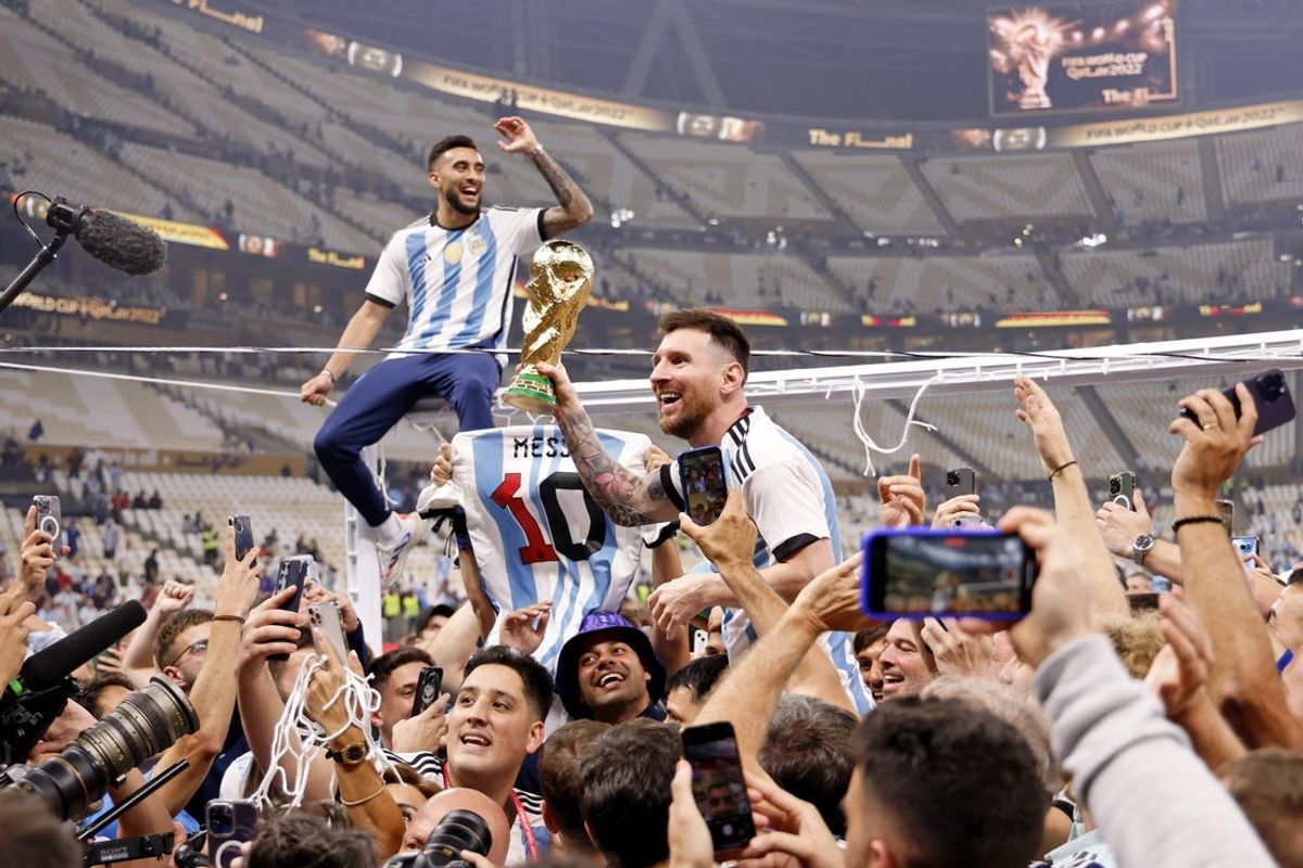 Dec 18, 2022; Lusail, Qatar; Argentina forward Lionel Messi (10) celebrates with fans after winning the 2022 World Cup final against France at Lusail Stadium. Mandatory Credit: Yukihito Taguchi-Imagn Images