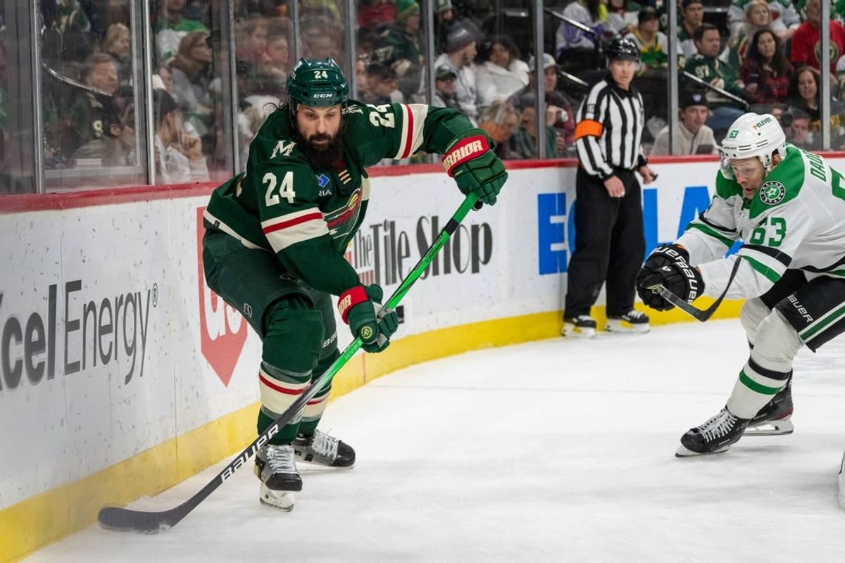 Jan 8, 2024; Saint Paul, Minnesota, USA; Minnesota Wild defenseman Zach Bogosian (24) clears the puck, pressed by Dallas Stars right wing Evgenii Dadonov (63) in the third period at Xcel Energy Center.