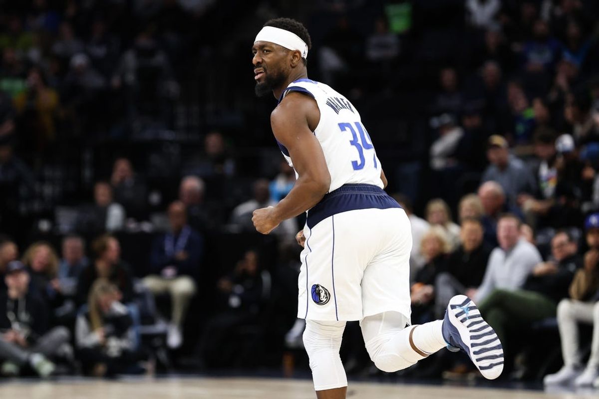 Dec 21, 2022; Minneapolis, Minnesota, USA; Dallas Mavericks guard Kemba Walker (34) reacts to his shot against the Minnesota Timberwolves during the second period at Target Center. Mandatory Credit: Matt Krohn-USA TODAY Sports