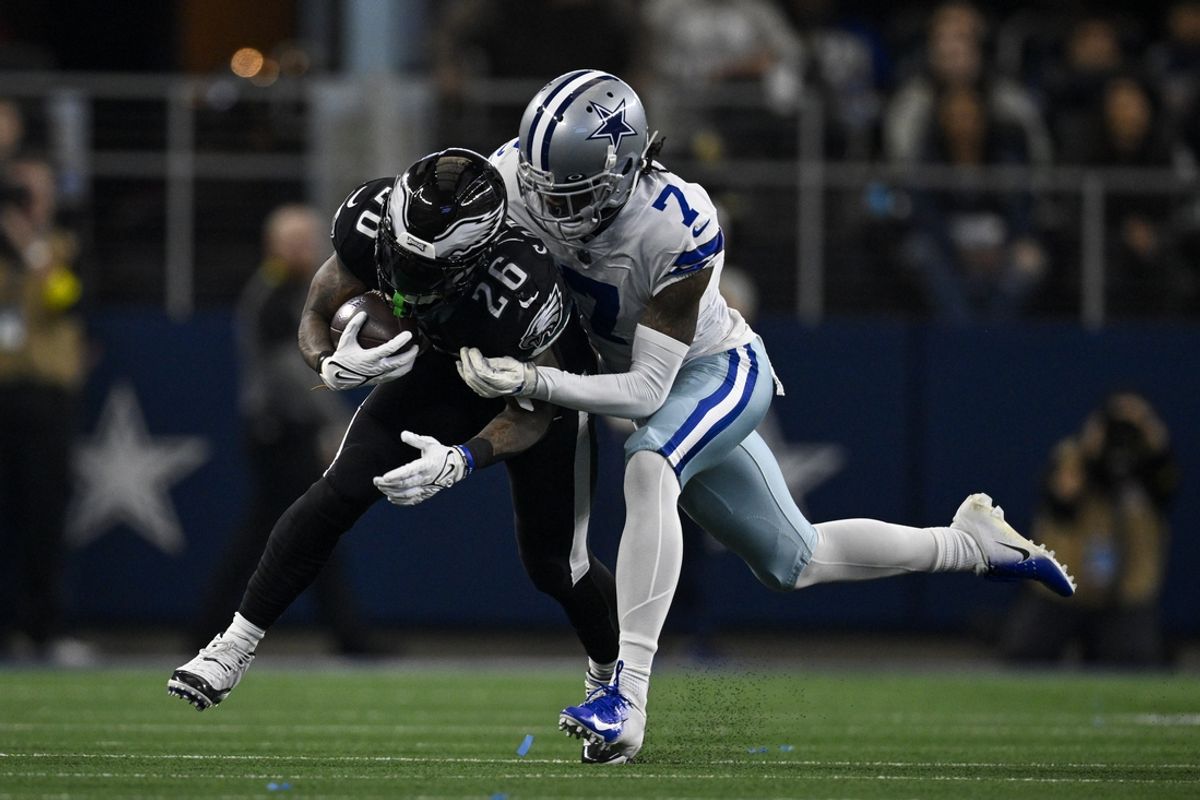 Dec 24, 2022; Arlington, Texas, USA; Dallas Cowboys cornerback Trevon Diggs (7) tackles Philadelphia Eagles running back Miles Sanders (26) during the first quarter at AT&T Stadium. Mandatory Credit: Jerome Miron-USA TODAY Sports