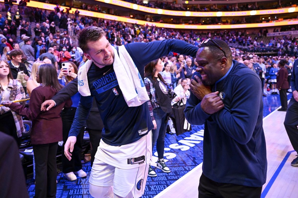 Dec 29, 2022; Dallas, Texas, USA; Dallas Mavericks guard Luka Doncic (left) and Mavericks assistant coach Darrell Armstrong walk off the court after the game against the Houston Rockets at the American Airlines Center. Mandatory Credit: Jerome Miron-Imagn Images