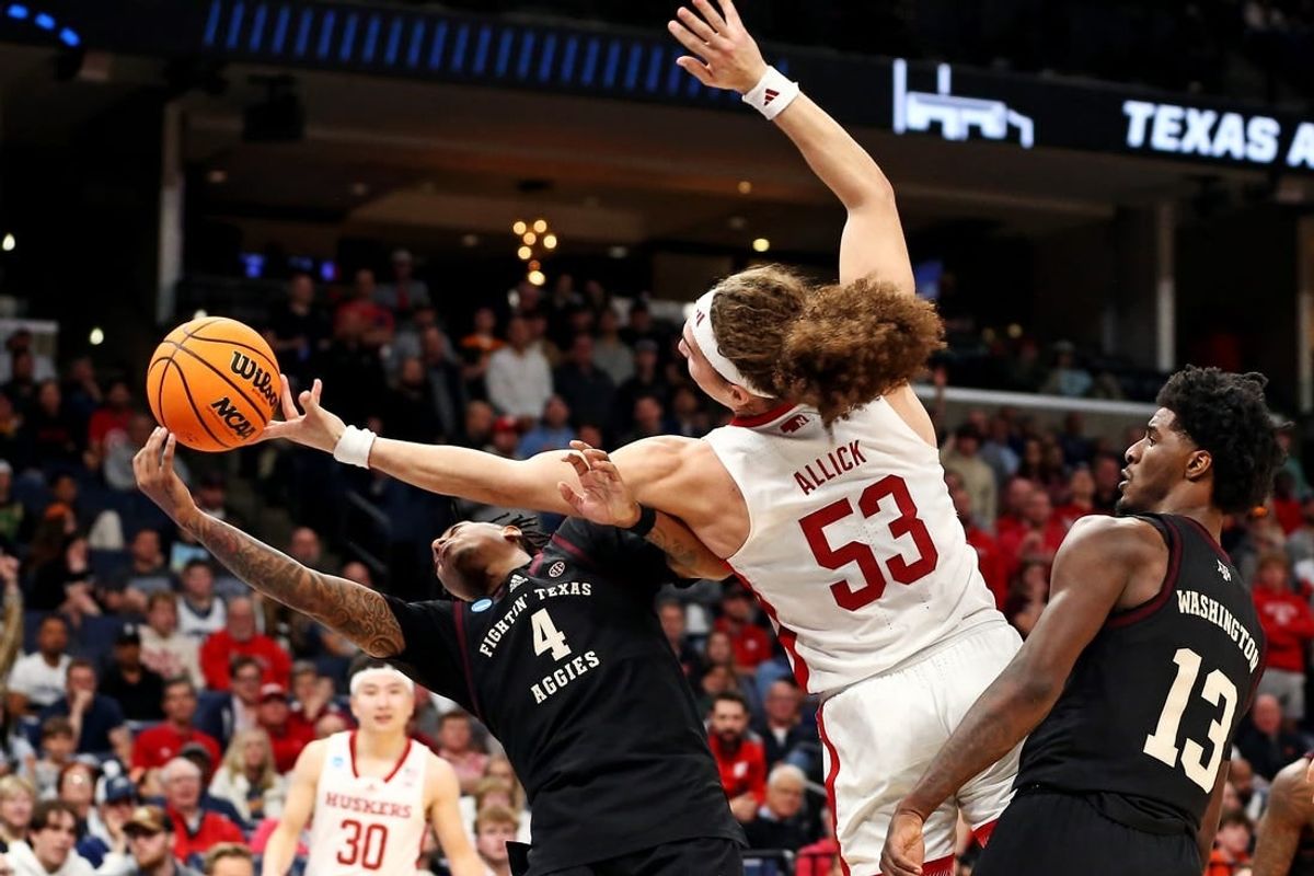 Mar 22, 2024; Memphis, TN, USA;  Texas A&M Aggies guard Wade Taylor IV (4) and Nebraska Cornhuskers forward Josiah Allick (53) go for the ball during the second half in the first round of the 2024 NCAA Tournament at FedExForum.