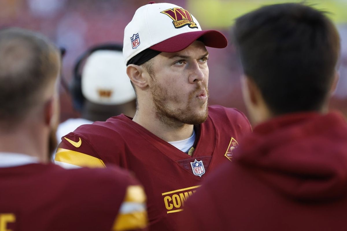 Jan 1, 2023; Landover, Maryland, USA; Washington Commanders quarterback Taylor Heinicke (4) stands on the sidelines against the Cleveland Browns during the fourth quarter at FedExField. Mandatory Credit: Geoff Burke-Imagn Images