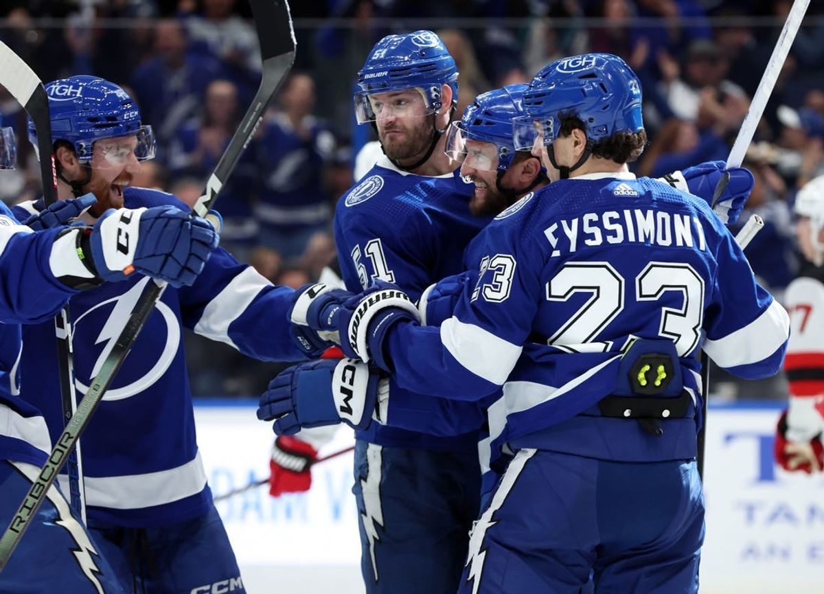 Jan 11, 2024; Tampa, Florida, USA; Tampa Bay Lightning center Luke Glendening (11) is congratulated after he scored a goal against the New Jersey Devils during the first period at Amalie Arena.