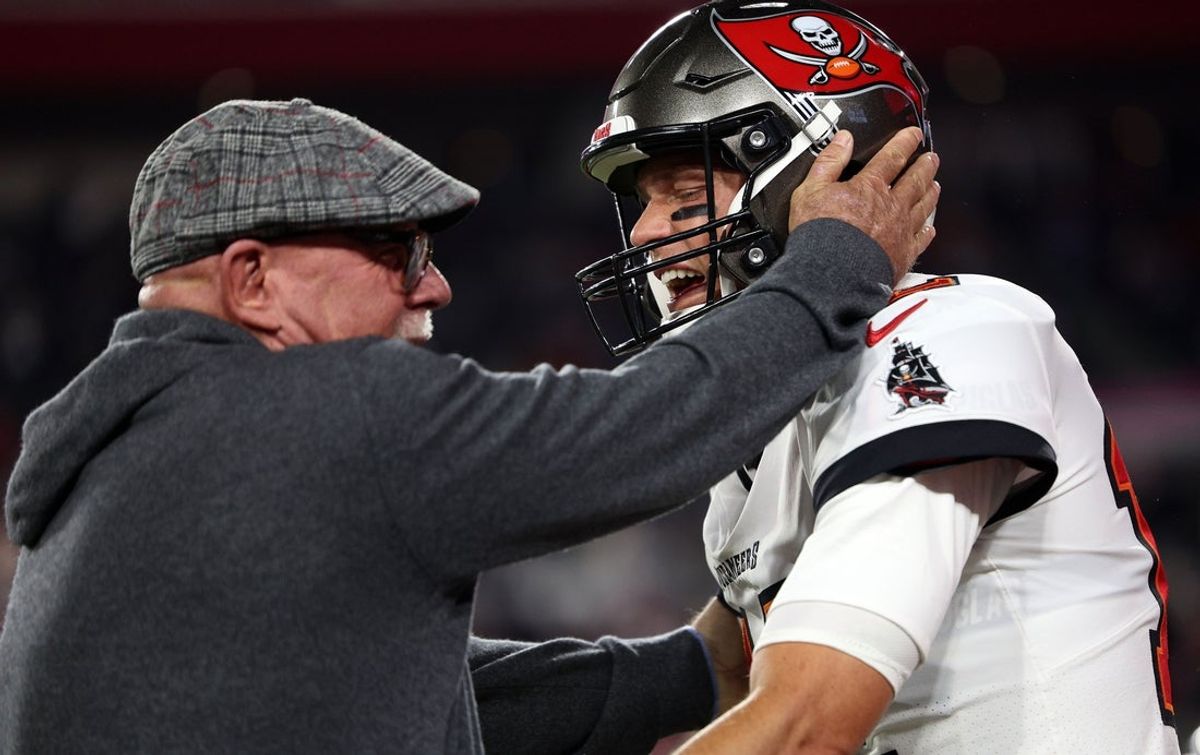 Jan 16, 2023; Tampa, Florida, USA; Tampa Bay Buccaneers senior football consultant Bruce Arians reacts with quarterback Tom Brady (12) against the Dallas Cowboys during a wild card game at Raymond James Stadium. Mandatory Credit: Nathan Ray Seebeck-Imagn Images