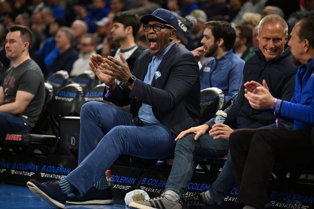 Jan 18, 2023; Chicago, Illinois, USA; Former DePaul Blue Demons basketball player Mark Aguirre cheers while watching the Blue Demons take on the Xavier Musketeers in the first half at Wintrust Arena. Mandatory Credit: Jamie Sabau-Imagn Images