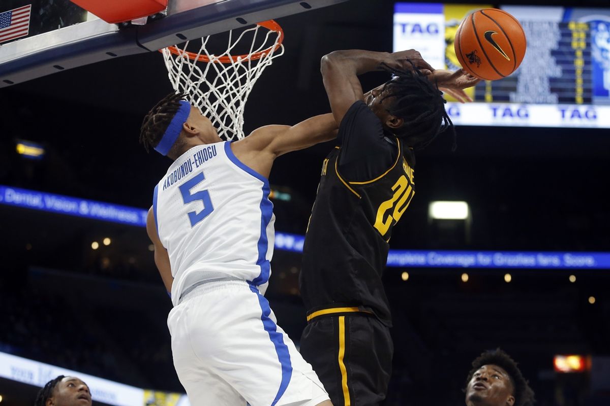 Jan 19, 2023; Memphis, Tennessee, USA; Memphis Tigers forward Kaodirichi Akobundu-Ehiogu (5) blocks the shot of Wichita State Shockers forward Isaac Abidde (24) during the first half at FedExForum. Mandatory Credit: Petre Thomas-Imagn Images