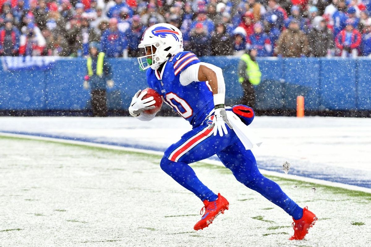 Jan 22, 2023; Orchard Park, New York, USA; Buffalo Bills running back Nyheim Hines (20) runs with the ball against the Cincinnati Bengals during the first half of an AFC divisional round game at Highmark Stadium. Mandatory Credit: Mark Konezny-Imagn Images