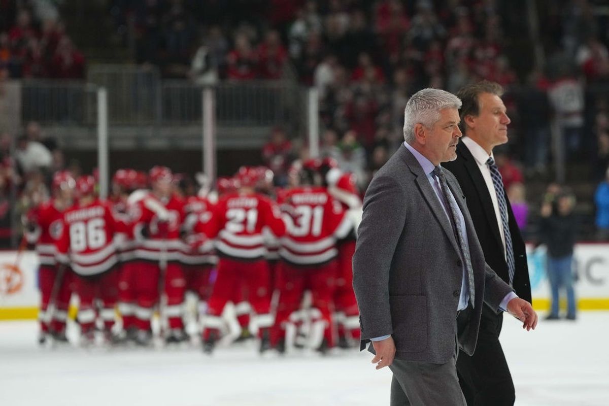 Jan 31, 2023; Raleigh, North Carolina, USA; Los Angeles Kings head coach Todd McLellan goes off the ice with assistant coach Jim Hiller after their loss to the Carolina Hurricanes in the overtime at PNC Arena. Mandatory Credit: James Guillory-USA TODAY Sports