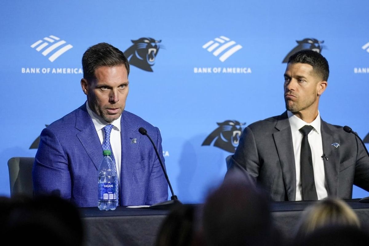Feb 1, 2024; Charlotte, NC, USA; Carolina Panthers general manager Dan Morgan (left) speaks with new coach Dave Canales during the introductory press conference at Bank of America Stadium.