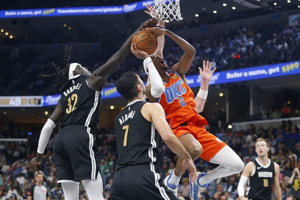 Mar 16, 2024; Memphis, Tennessee, USA; Oklahoma City Thunder guard Shai Gilgeous-Alexander (2) shoots as Memphis Grizzlies forward Wenyen Gabriel (32) defends during the first half at FedExForum.