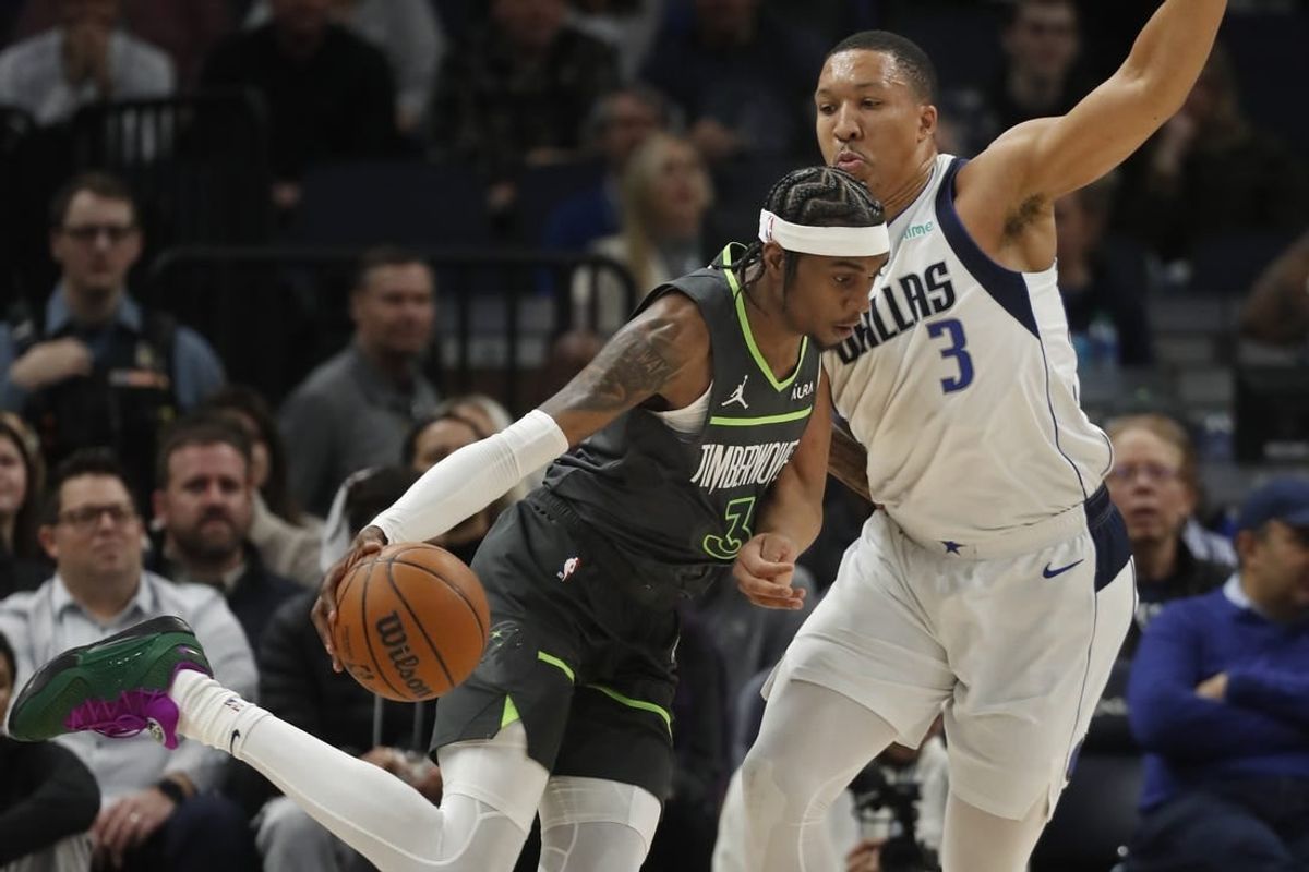 Jan 31, 2024; Minneapolis, Minnesota, USA; Minnesota Timberwolves forward Jaden McDaniels (3) works around Dallas Mavericks forward Grant Williams (3) in the first quarter at Target Center.