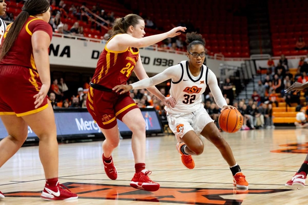 Dec 30, 2023; Stillwater, Okla, USA ; Oklahoma State Cowgirls guard Stailee Heard (32) drives past Iowa State Cyclones forward Addy Brown (24) in the first half of an NCAA women  s basketball game at Gallagher Iba arena.