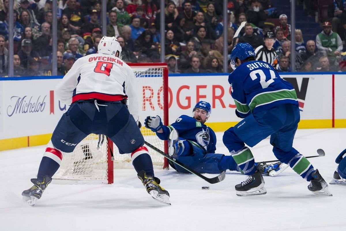 Mar 16, 2024; Vancouver, British Columbia, CAN; Vancouver Canucks defenseman Filip Hronek (17) and forward Pius Suter (24) watch as Washington Capitals forward Alex Ovechkin (8) scores on the Vancouver goal in the second period at Rogers Arena.