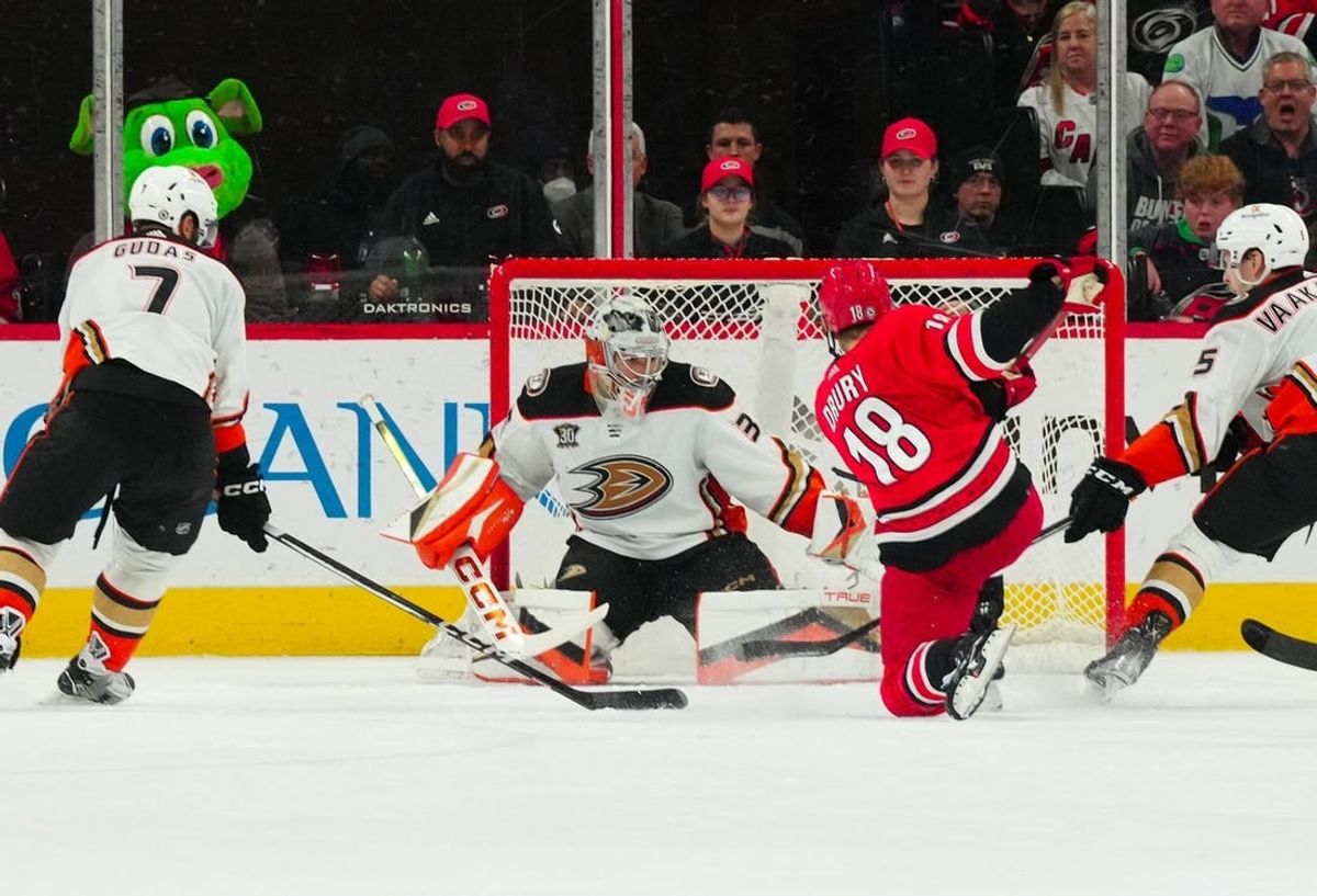 Jan 11, 2024; Raleigh, North Carolina, USA; Carolina Hurricanes center Jack Drury (18) scores a goal past Anaheim Ducks goaltender John Gibson (36) during the second period at PNC Arena.