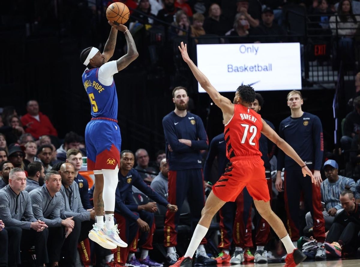 Mar 23, 2024; Portland, Oregon, USA;  Denver Nuggets guard Kentavious Caldwell-Pope (5) shoots the ball over Portland Trail Blazers guard Rayan Rupert (72) in the first quarter at Moda Center.